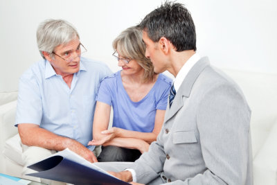 consultant talking to senior couple at home